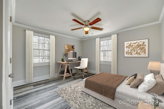 bedroom with crown molding, ceiling fan, and wood-type flooring