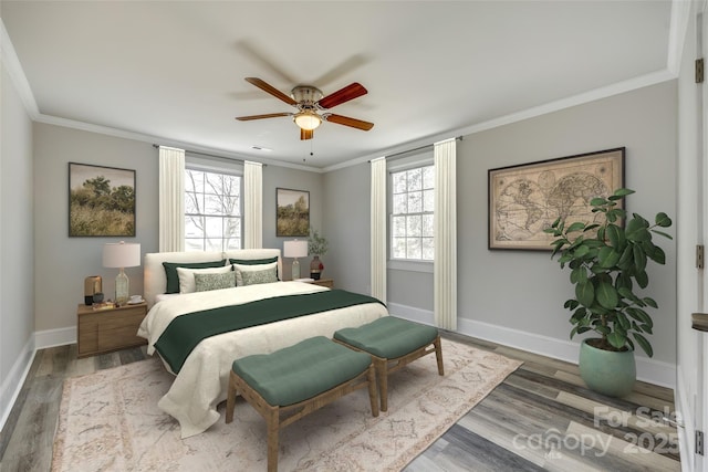 bedroom featuring hardwood / wood-style flooring, ornamental molding, and ceiling fan