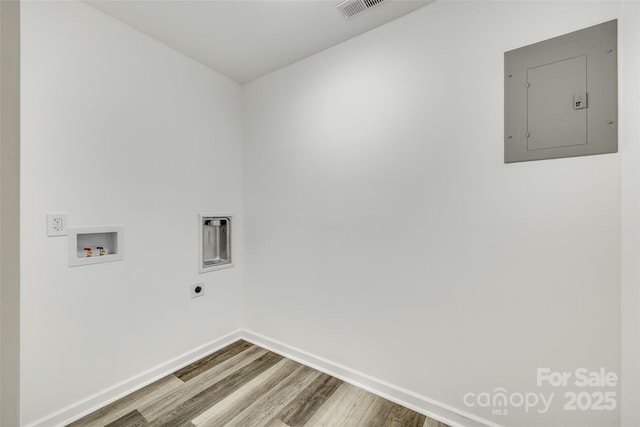 washroom featuring hookup for a washing machine, hardwood / wood-style floors, hookup for an electric dryer, and electric panel