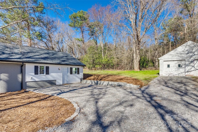 exterior space featuring a garage and an outdoor structure