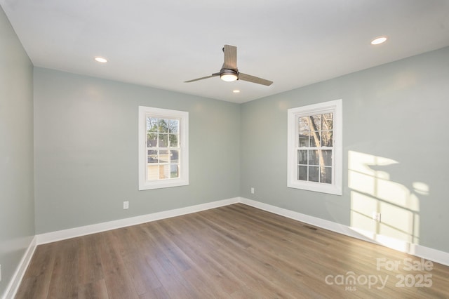 spare room with hardwood / wood-style flooring and ceiling fan