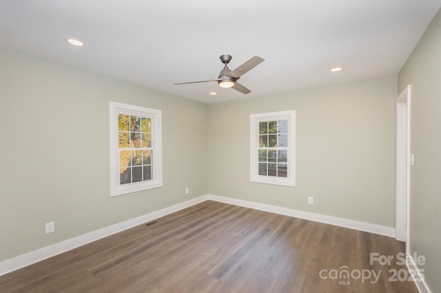 unfurnished room featuring wood-type flooring, plenty of natural light, and ceiling fan