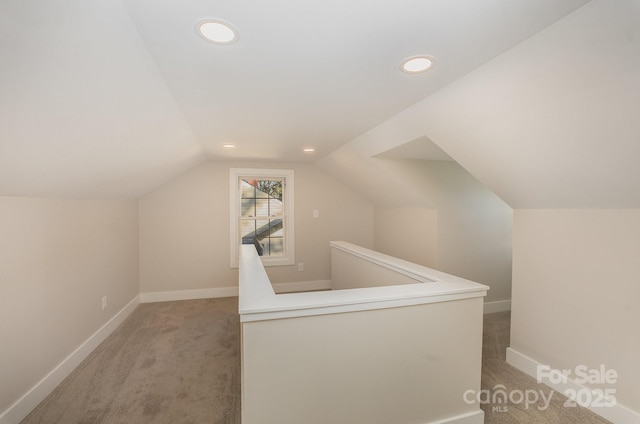 additional living space with lofted ceiling and carpet