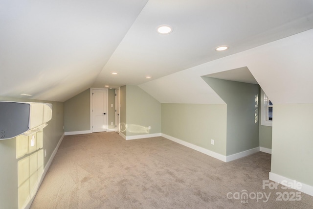 additional living space with lofted ceiling and light carpet