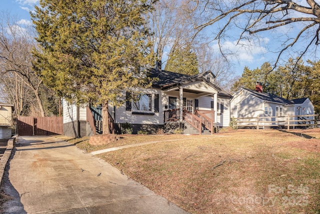 bungalow featuring a front yard and a porch