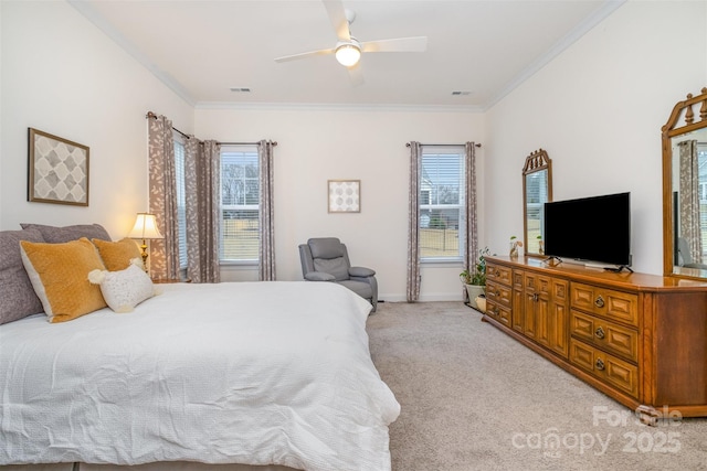 carpeted bedroom featuring crown molding and ceiling fan