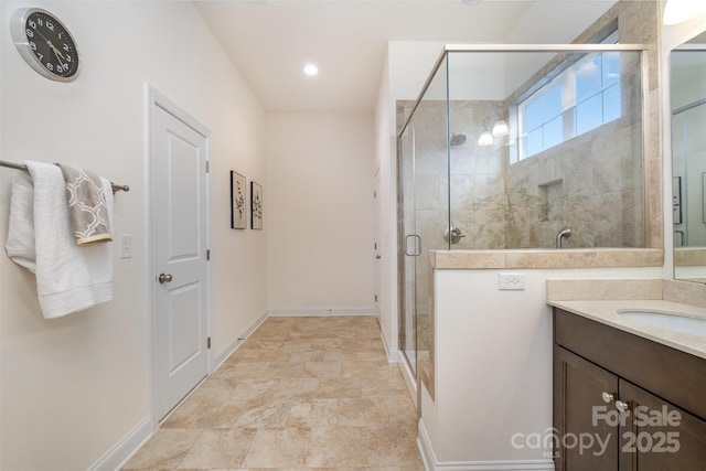 bathroom with a shower with door and vanity