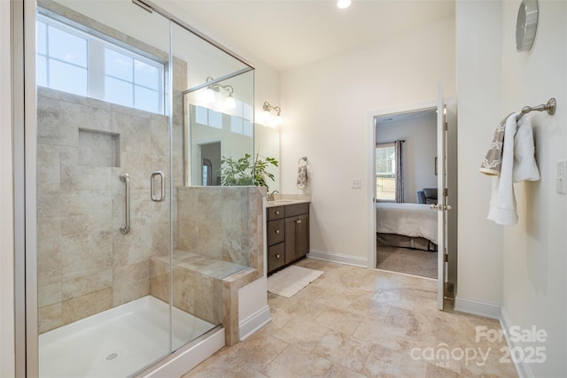 bathroom featuring a shower with door and vanity