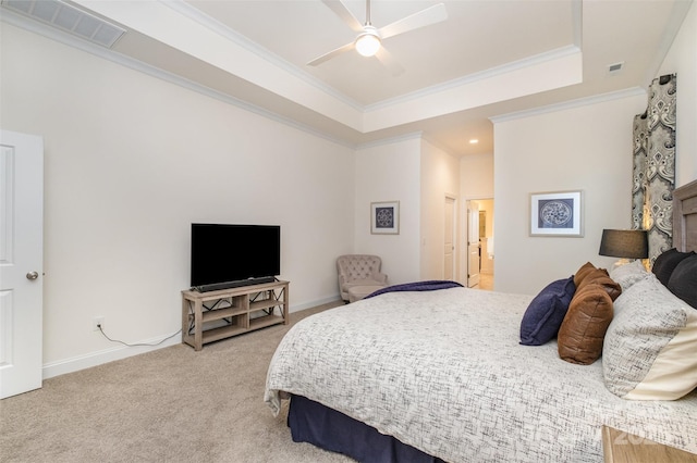 bedroom featuring ceiling fan, ornamental molding, a raised ceiling, and carpet floors