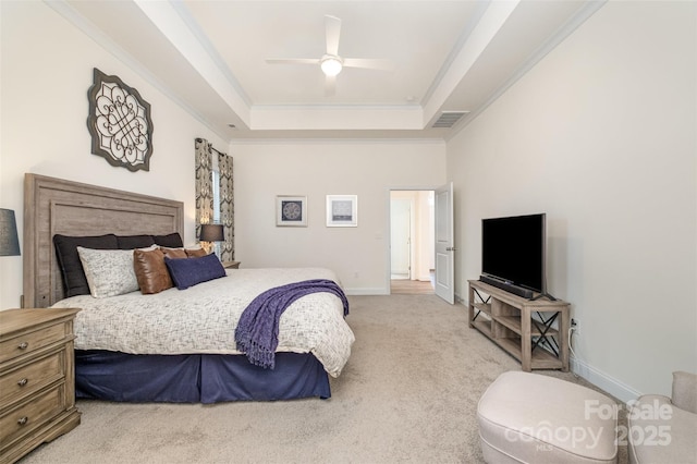 carpeted bedroom featuring crown molding, ceiling fan, and a raised ceiling