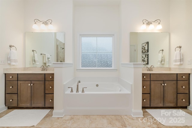 bathroom with vanity and a bath