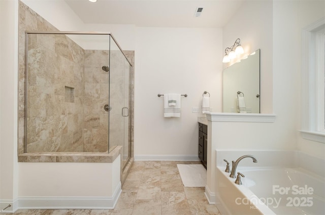 bathroom featuring vanity and independent shower and bath