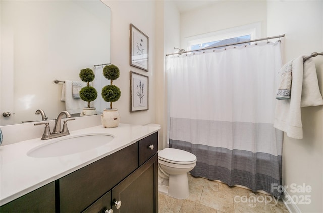 bathroom with vanity, toilet, and walk in shower