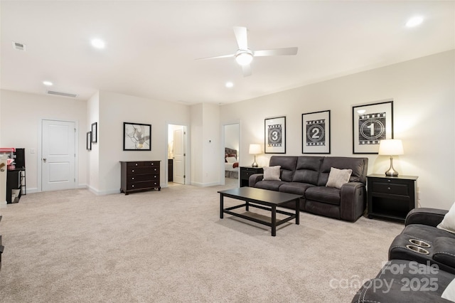 carpeted living room featuring ceiling fan