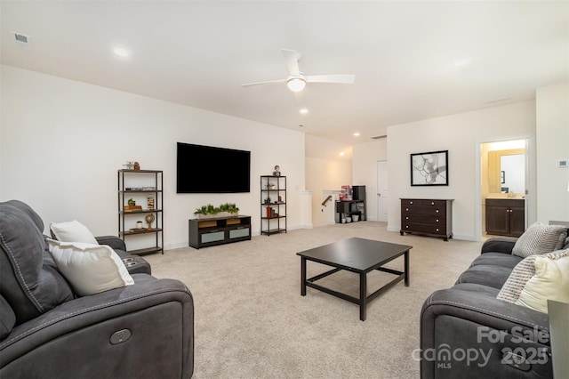 carpeted living room featuring ceiling fan