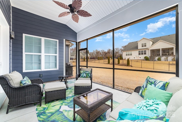 sunroom / solarium with lofted ceiling and ceiling fan