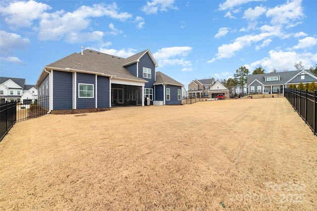 back of property with a sunroom