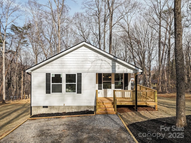 view of front facade with crawl space and a wooden deck