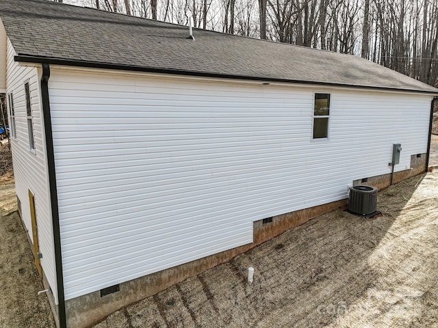 view of property exterior with crawl space, central air condition unit, and a shingled roof