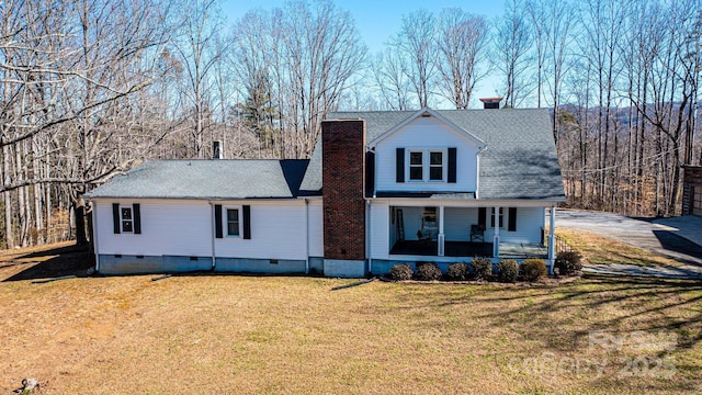 view of front of home with a chimney, a front lawn, crawl space, and a porch