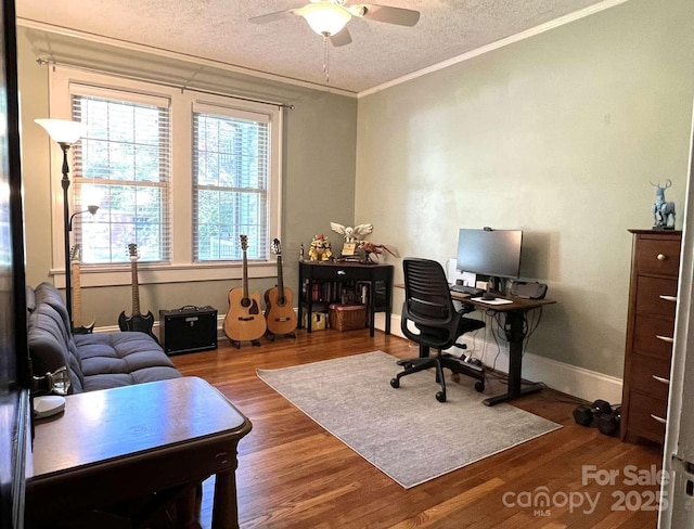 office area with ornamental molding, dark hardwood / wood-style floors, ceiling fan, and a textured ceiling