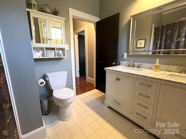 bathroom with tile patterned flooring, vanity, a shower with curtain, and toilet