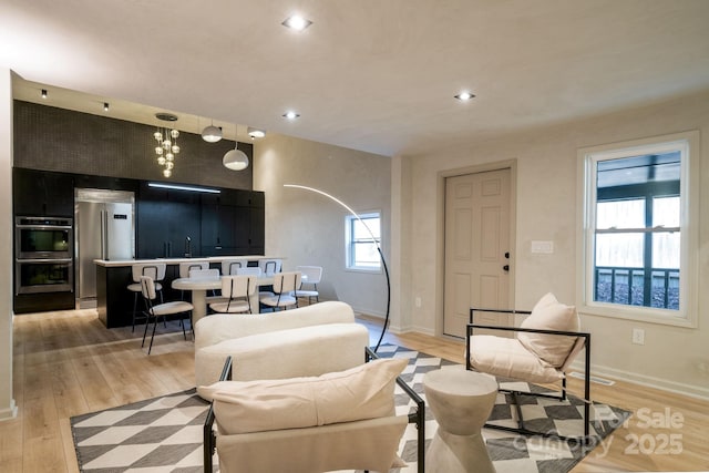 living room with sink and light hardwood / wood-style flooring