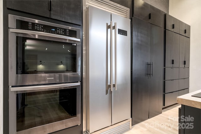 kitchen with stainless steel appliances and light hardwood / wood-style floors