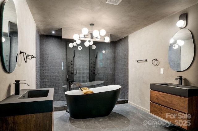 bathroom with an inviting chandelier, vanity, and shower with separate bathtub