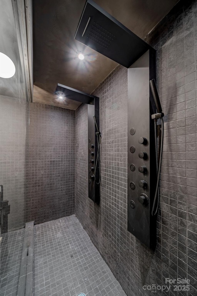 bathroom with tile walls and a tile shower