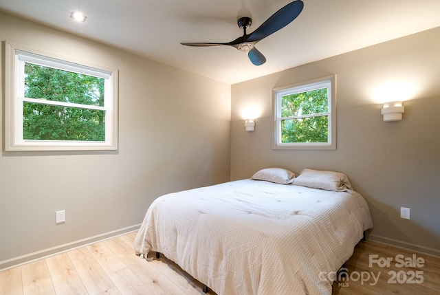 bedroom featuring light hardwood / wood-style floors and ceiling fan