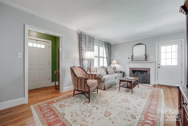 968 Waverly Ave, Rock Hill, SC 29730 - living area featuring plenty of natural light, crown molding, light wood-style floors, a brick fireplace, and baseboards