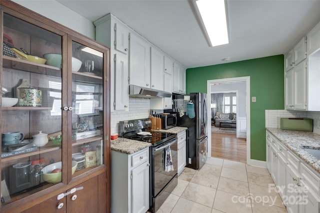 968 Waverly Ave, Rock Hill, SC 29730 - kitchen featuring black / electric stove, under cabinet range hood, freestanding refrigerator, backsplash, and white cabinetry