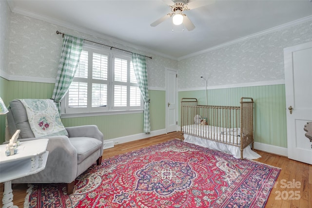 968 Waverly Ave, Rock Hill, SC 29730 - bedroom featuring wood finished floors, wainscoting, wallpapered walls, and a ceiling fan