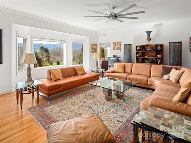 living room with crown molding, hardwood / wood-style floors, and ceiling fan