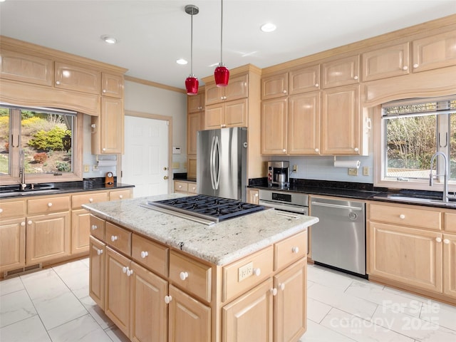 kitchen featuring pendant lighting, stainless steel appliances, a kitchen island, and light brown cabinets