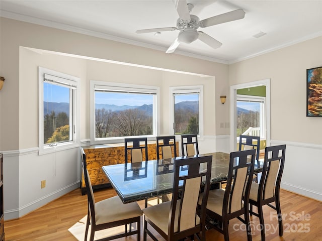 dining room featuring ornamental molding, ceiling fan, and light hardwood / wood-style flooring