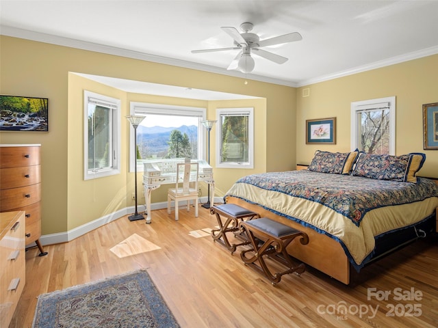 bedroom with ornamental molding, ceiling fan, and light wood-type flooring