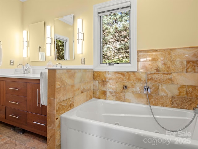 bathroom featuring vanity and a bath