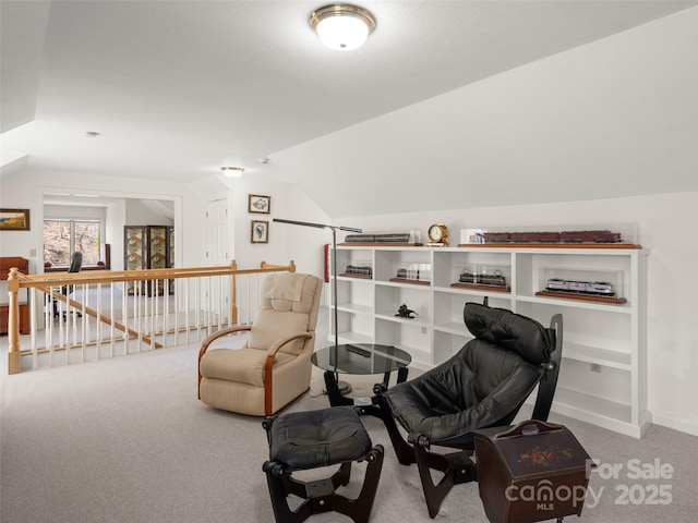 living area with lofted ceiling and carpet flooring