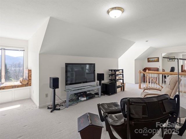 carpeted living room with vaulted ceiling