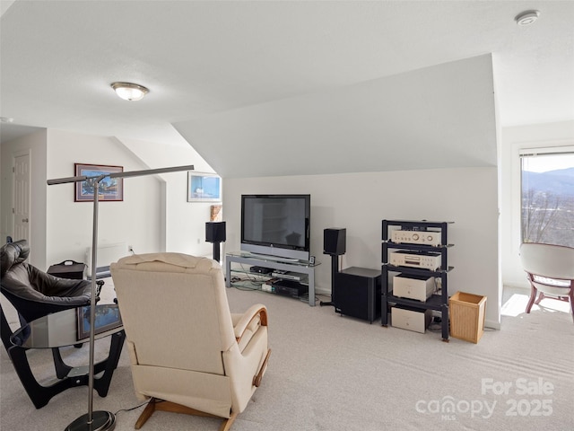 carpeted living room featuring lofted ceiling