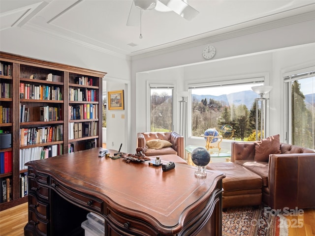 office space with crown molding, ceiling fan, and light hardwood / wood-style flooring