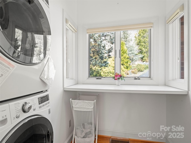 laundry room with stacked washer and dryer