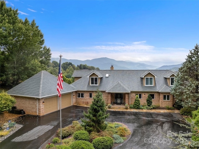 view of front of house featuring a garage and a mountain view