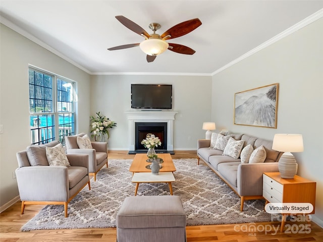 living room featuring hardwood / wood-style flooring, crown molding, and ceiling fan