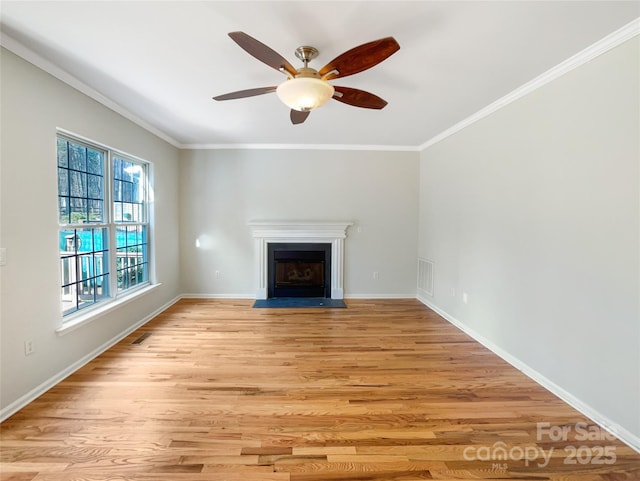 unfurnished living room featuring crown molding, ceiling fan, and light wood-type flooring