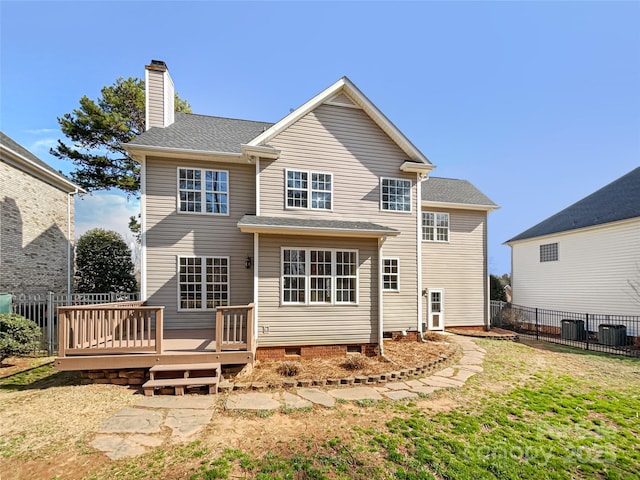 rear view of house featuring a wooden deck, a yard, and cooling unit