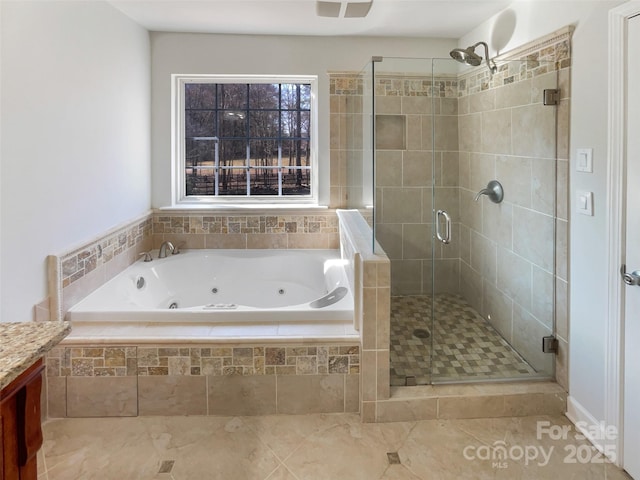 bathroom with vanity and shower with separate bathtub