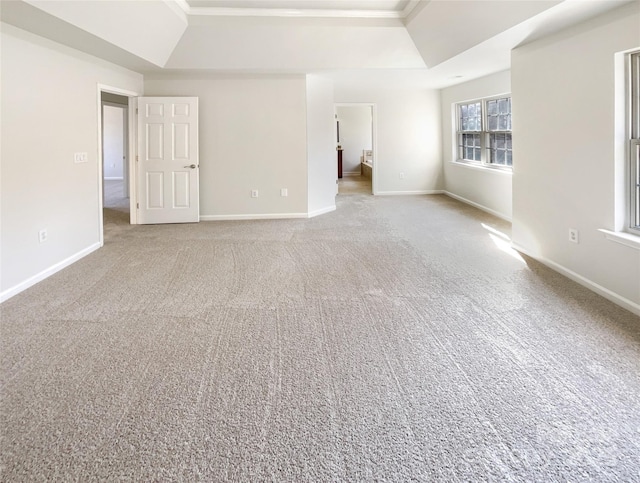 carpeted spare room with a tray ceiling